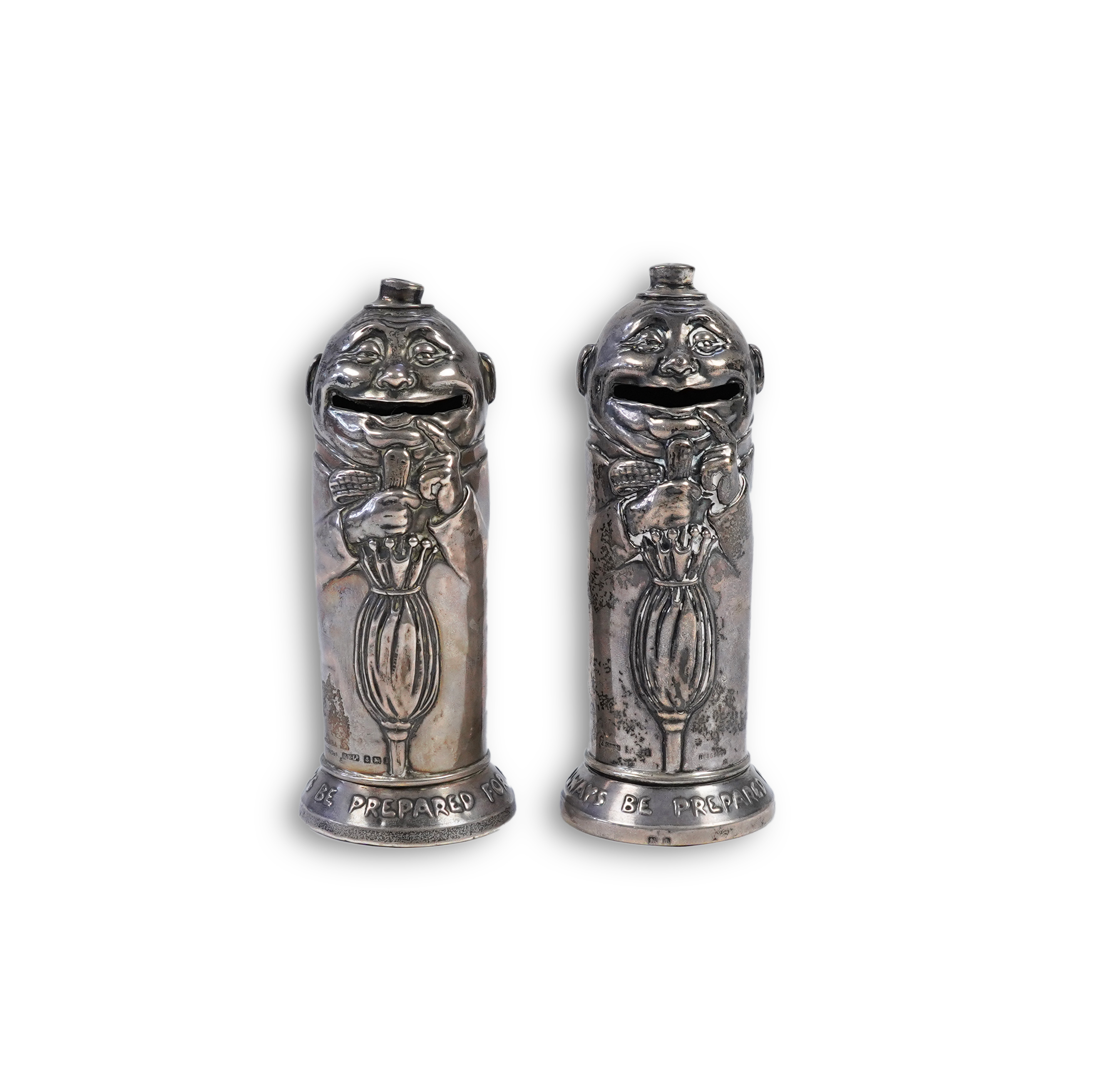 A matched pair of George V novelty silver money boxes, each cylindrical box embossed as a banker with an umbrella, the circular base inscribed 'Always be prepared for a rainy day'